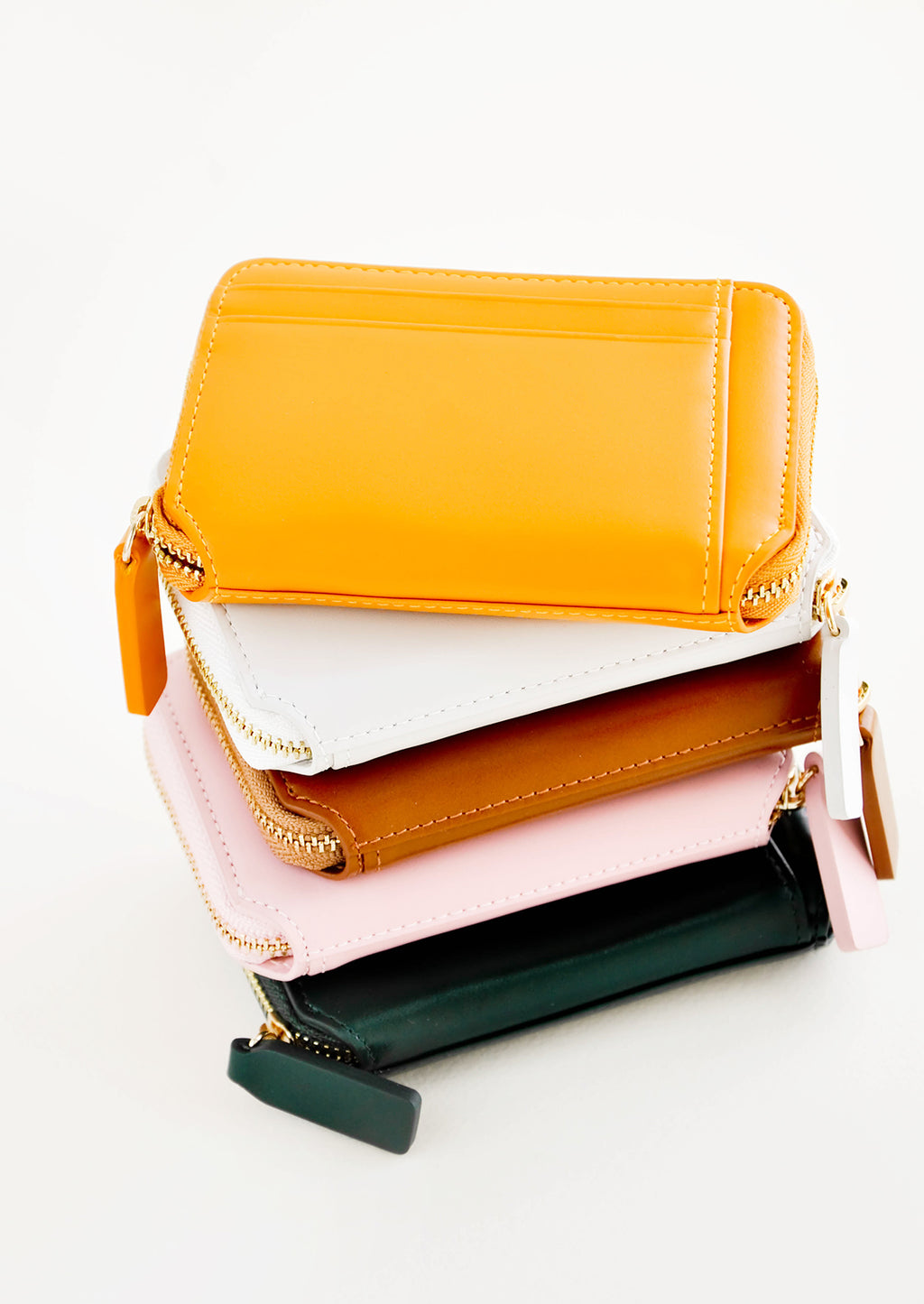 3: Stack of colorful leather zip wallets.