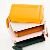 3: Stack of colorful leather zip wallets.