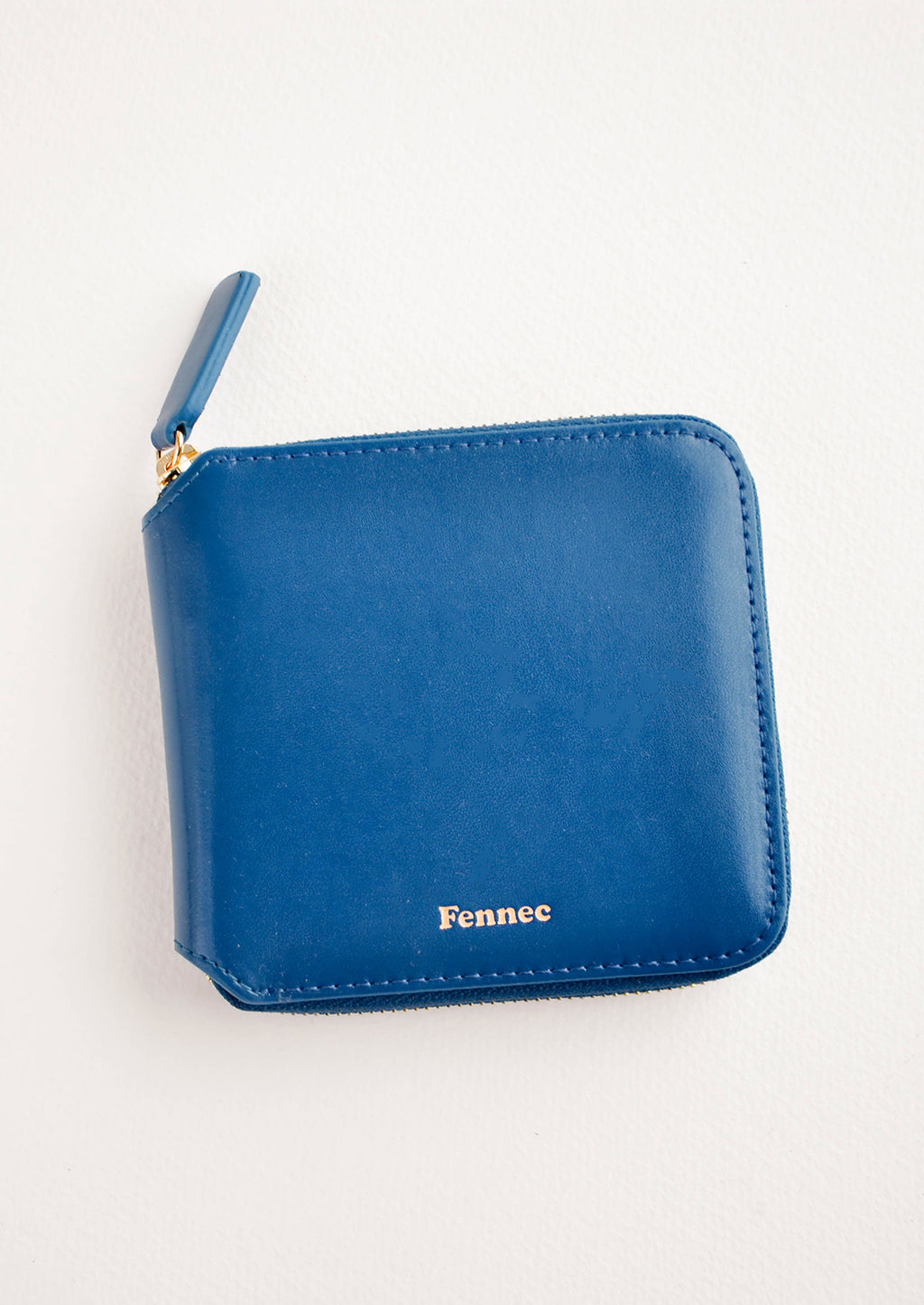 Deep Blue: Dark blue leather wallet that zips on three sides, with matching tab pull.