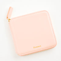 Peach: Light pink leather wallet that zips on three sides, with matching tab pull.