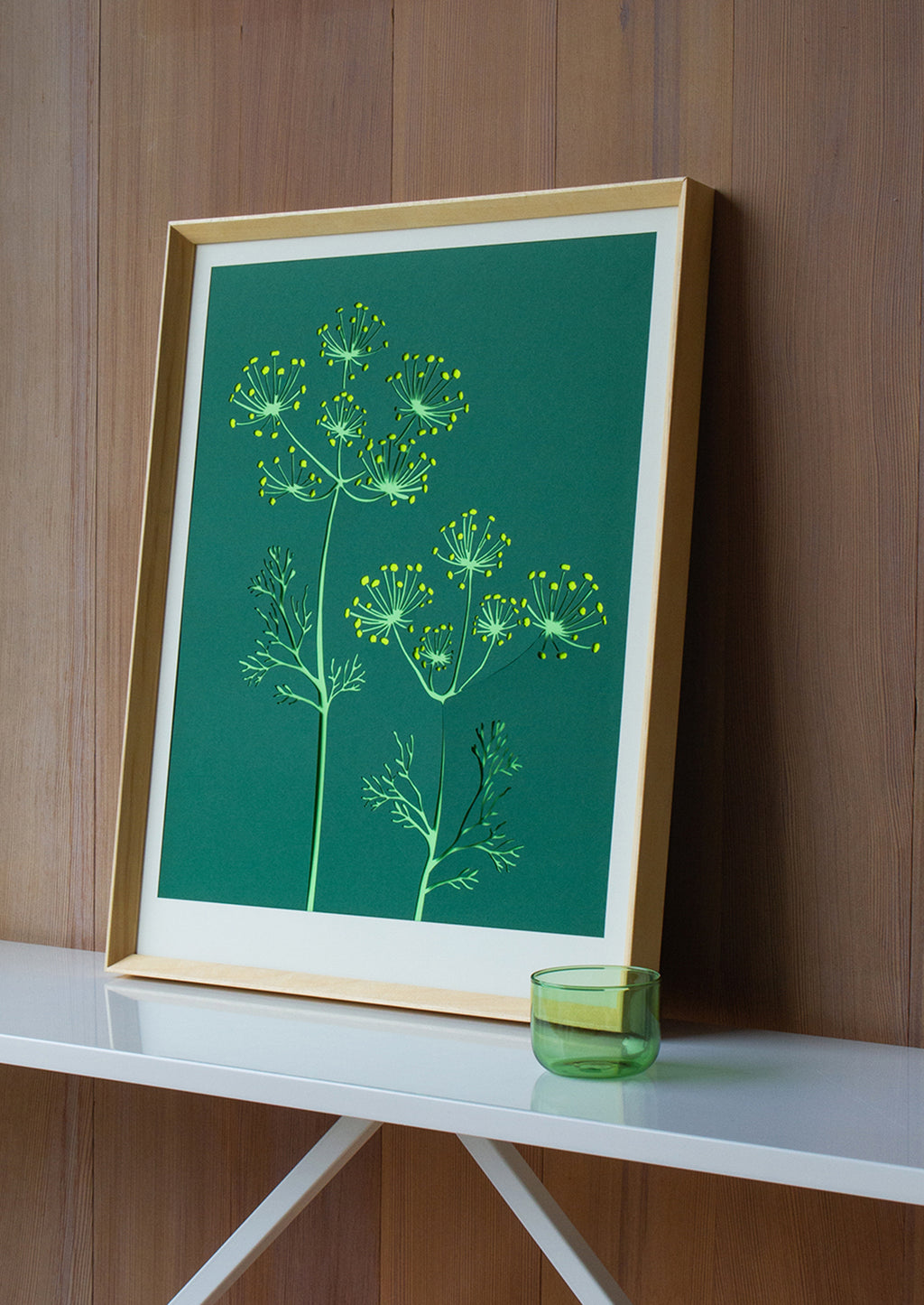 2: A lasercut art print depicting fennel flowers on dark green background.