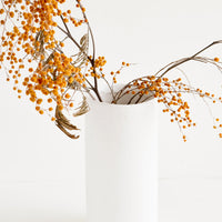 Tall: Tall and narrow cylindrical vase in white concrete material, displaying dried mimosa