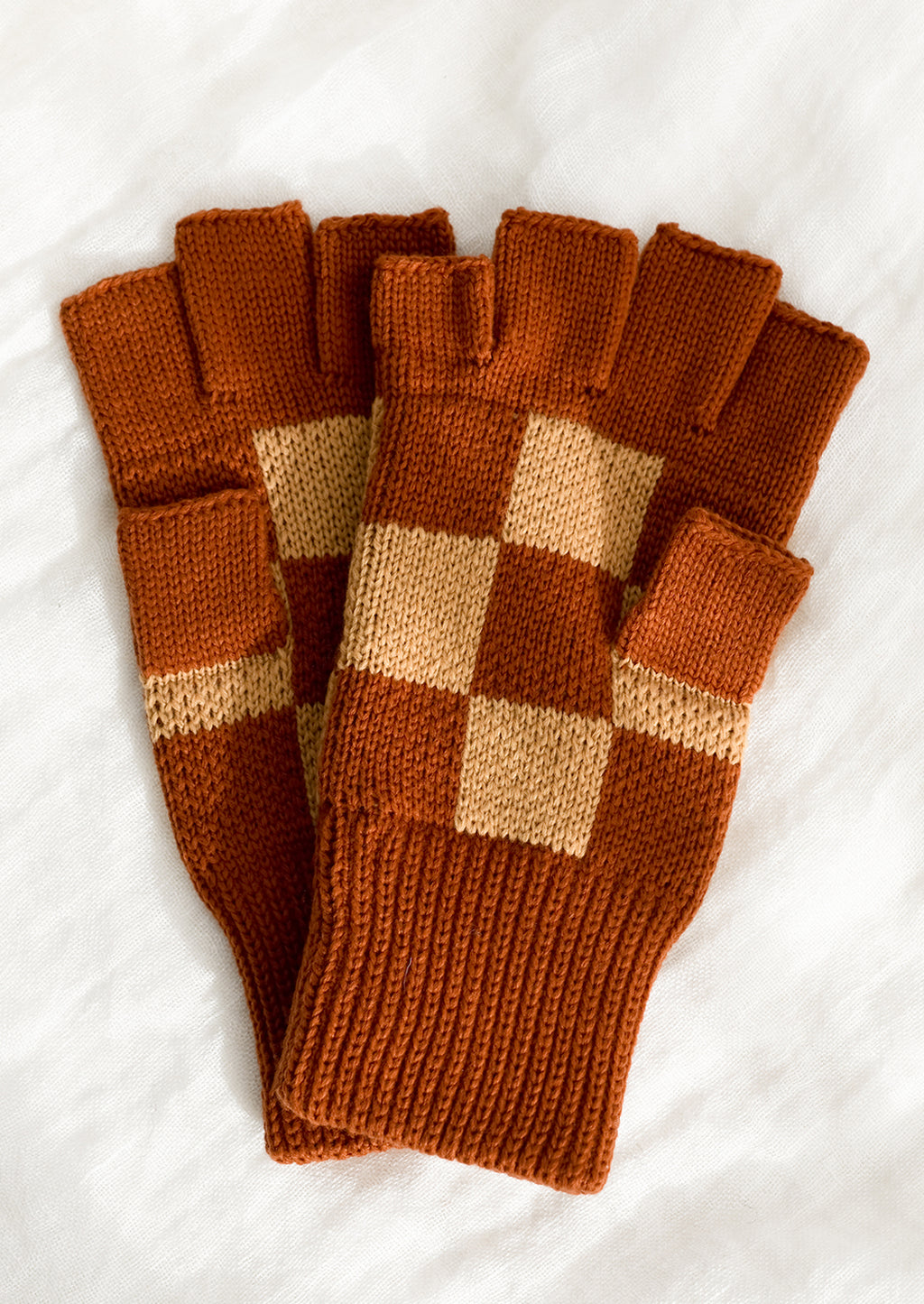 Terracotta Checker: A pair of knit fingerless gloves in terracotta checker.