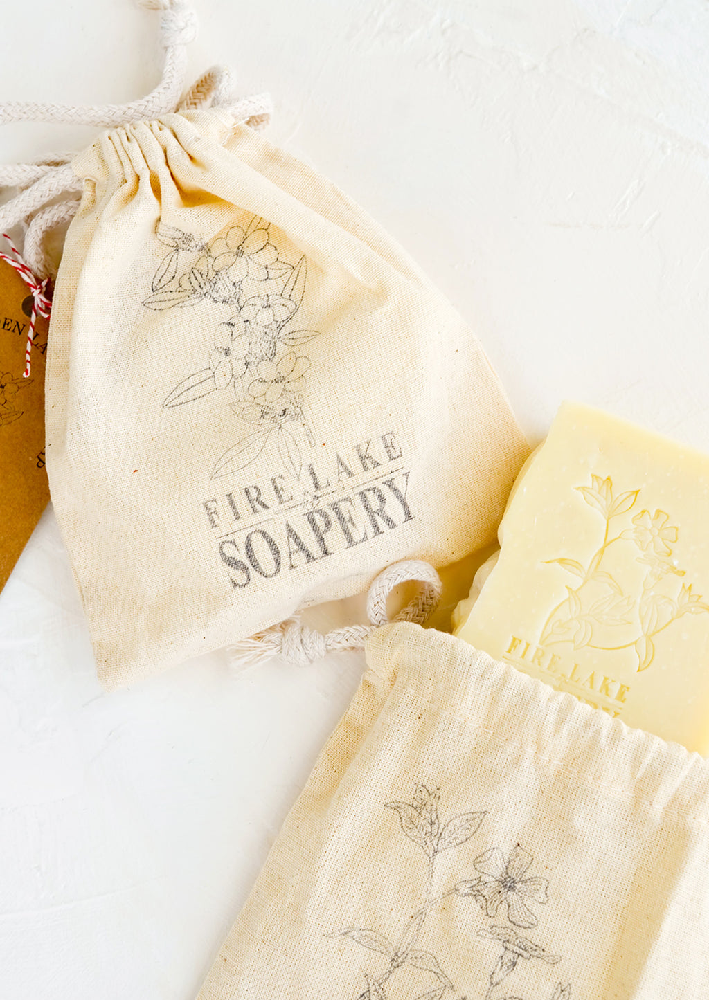 2: Floral stamped muslin bags containing bar soap.