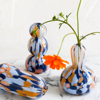 2: Blue and orange speckle patterned glass vases in assorted shapes.