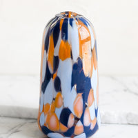 Tapered: A tapered bud vase in hand blown glass with blue and orange speckle pattern.