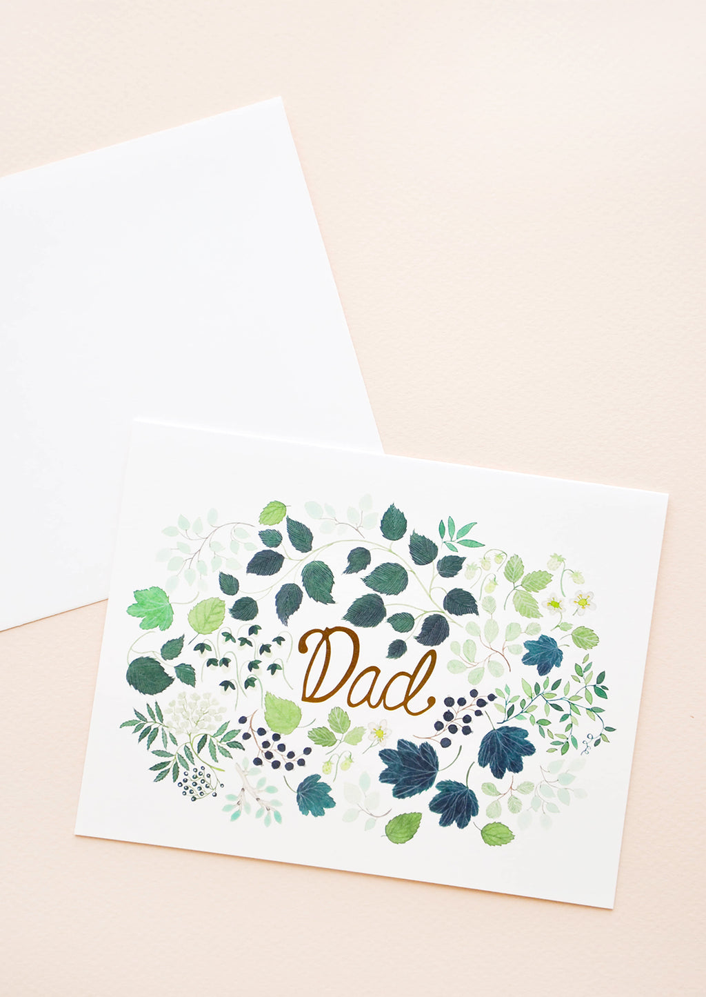 1: Greeting card with green floral print frame around "Dad" printed in gold text