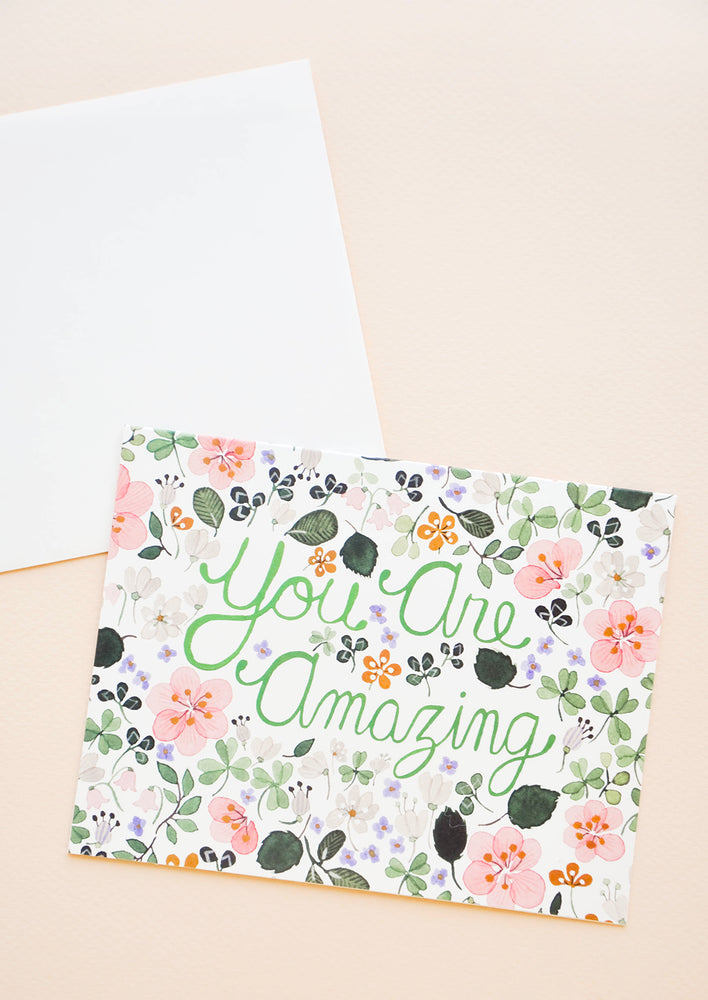 Greeting card with allover floral print and text reading "You Are Amazing"
