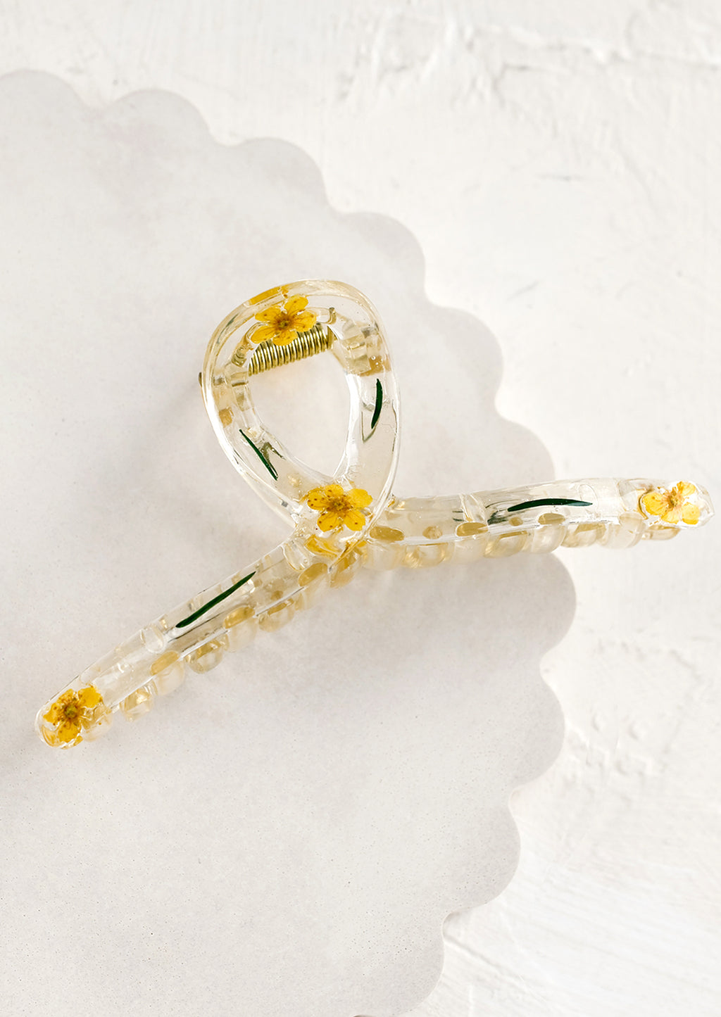 Yellow: A clear crescent shaped hair claw with yellow dried flowers.