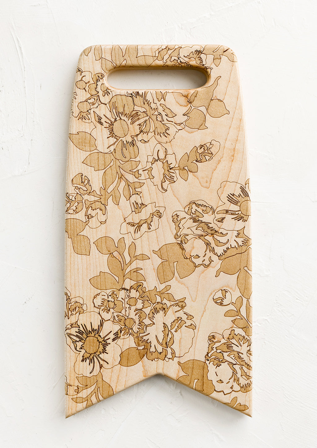 1: Flag shaped maplewood cutting board with handle cutout, lasercut floral pattern
