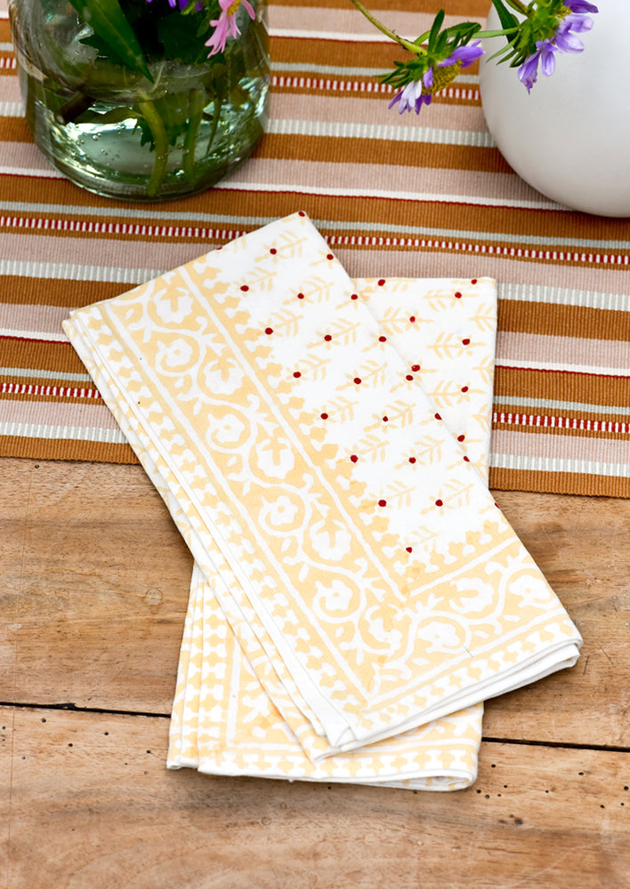 2: A pair of napkins on a table.