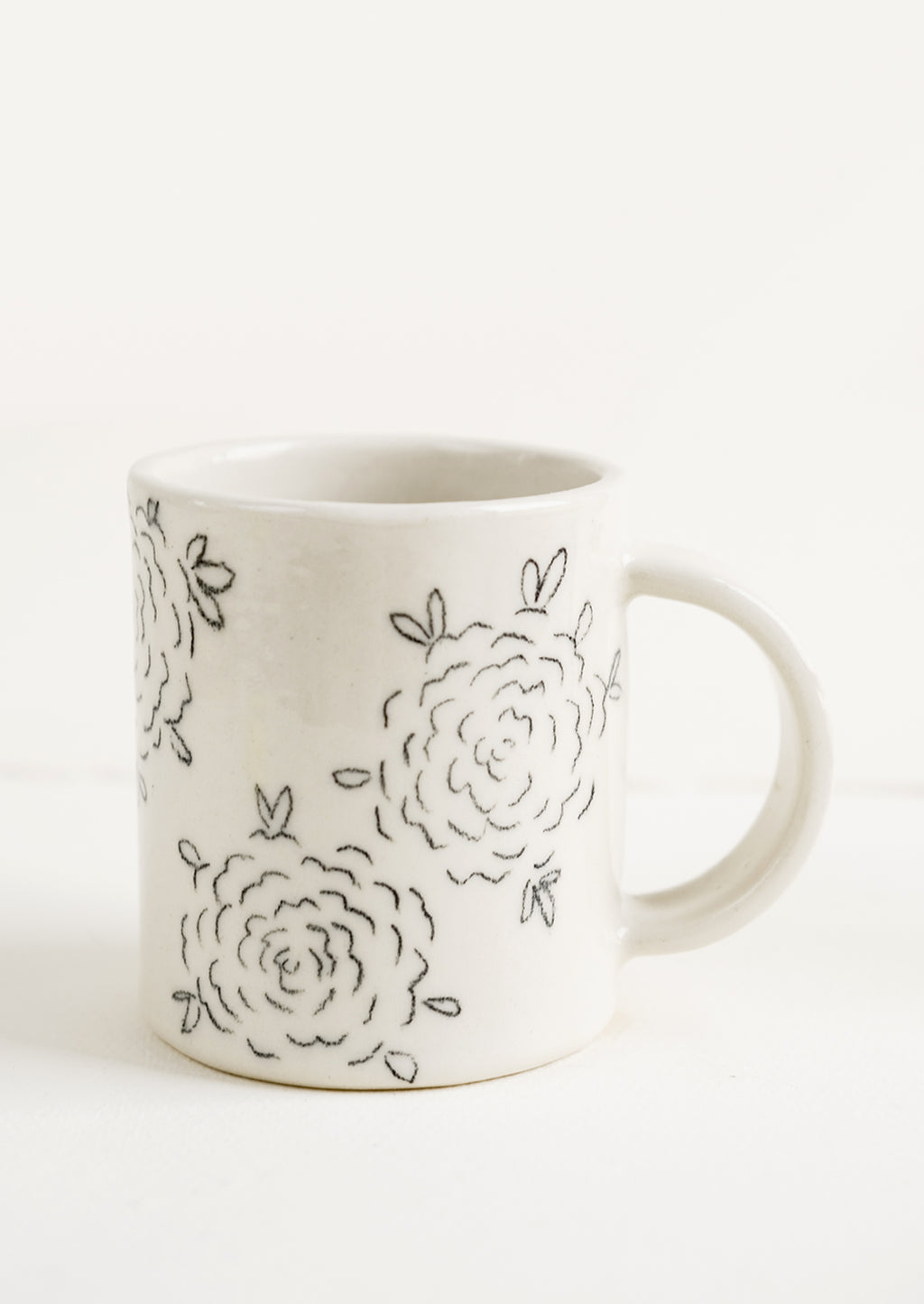 Line Drawing Floral: A handmade ceramic mug with white background and hand-painted floral line drawing print in black.