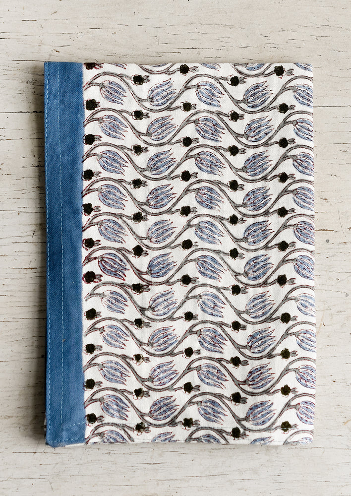A tea towel with dusty blue print and trim.