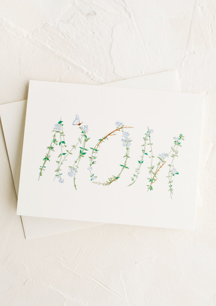 A mother's day greeting card with "mom" written out in flowers.