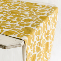 3: A mustard floral print table runner.