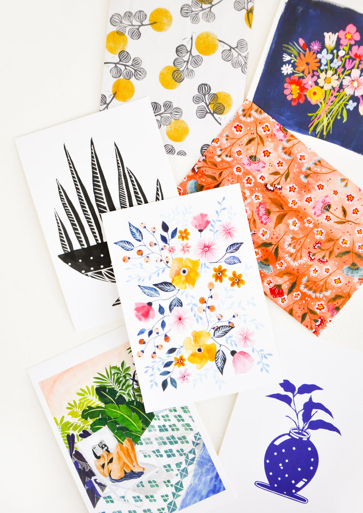 Product shot showing multiple styles of floral postcards.