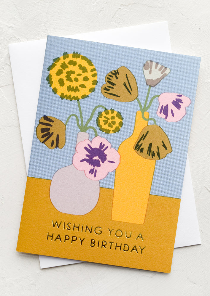 A card with drawing of flowers in vases, text at bottom reads "Wishing you a happy birthday".