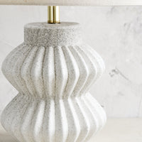 2: A table lamp with fluted ceramic base in speckled gray.