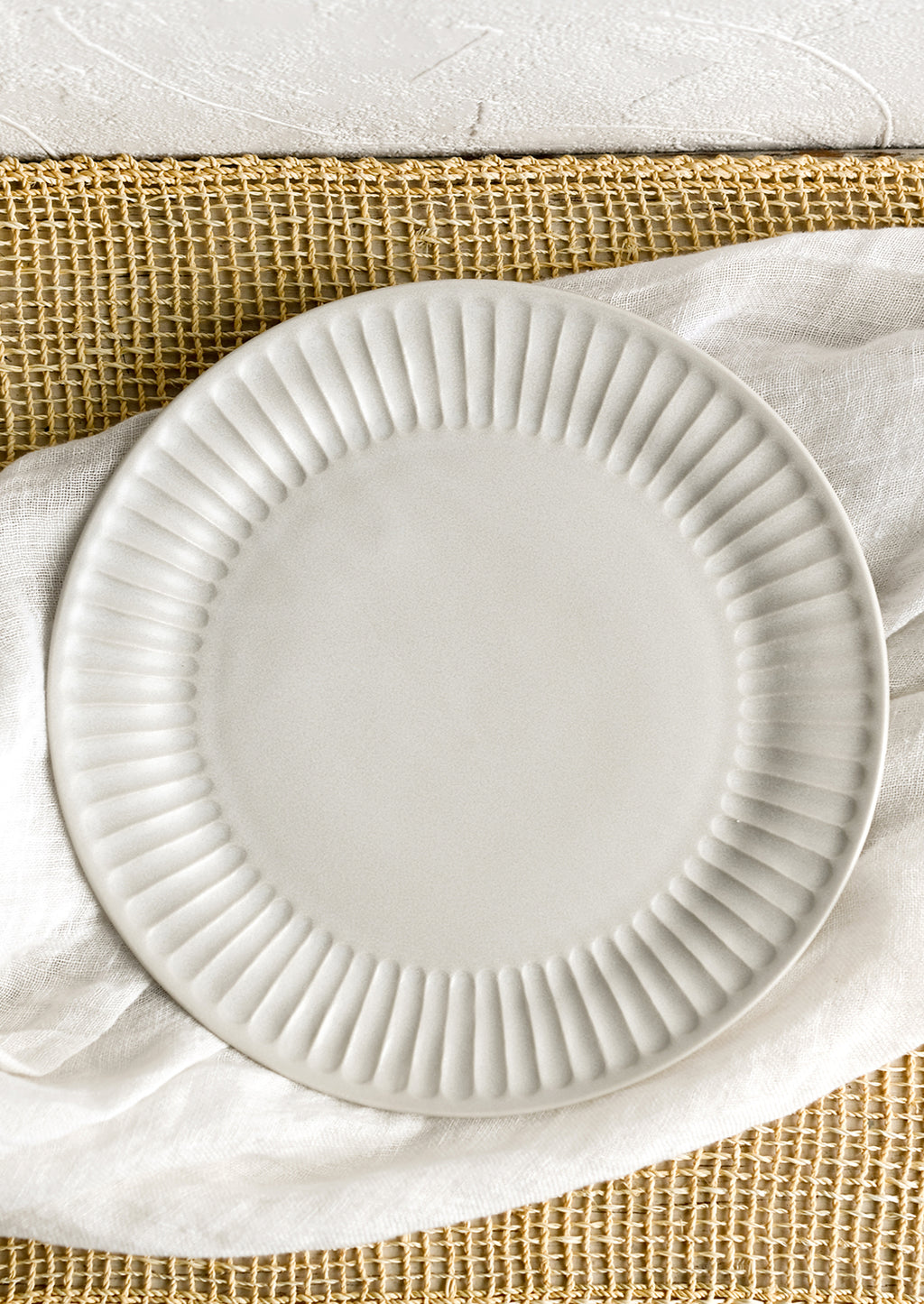 1: A white porcelain plate with fluted texture around rim.