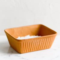 1: A rectangular dish with fluted texture in terracotta.