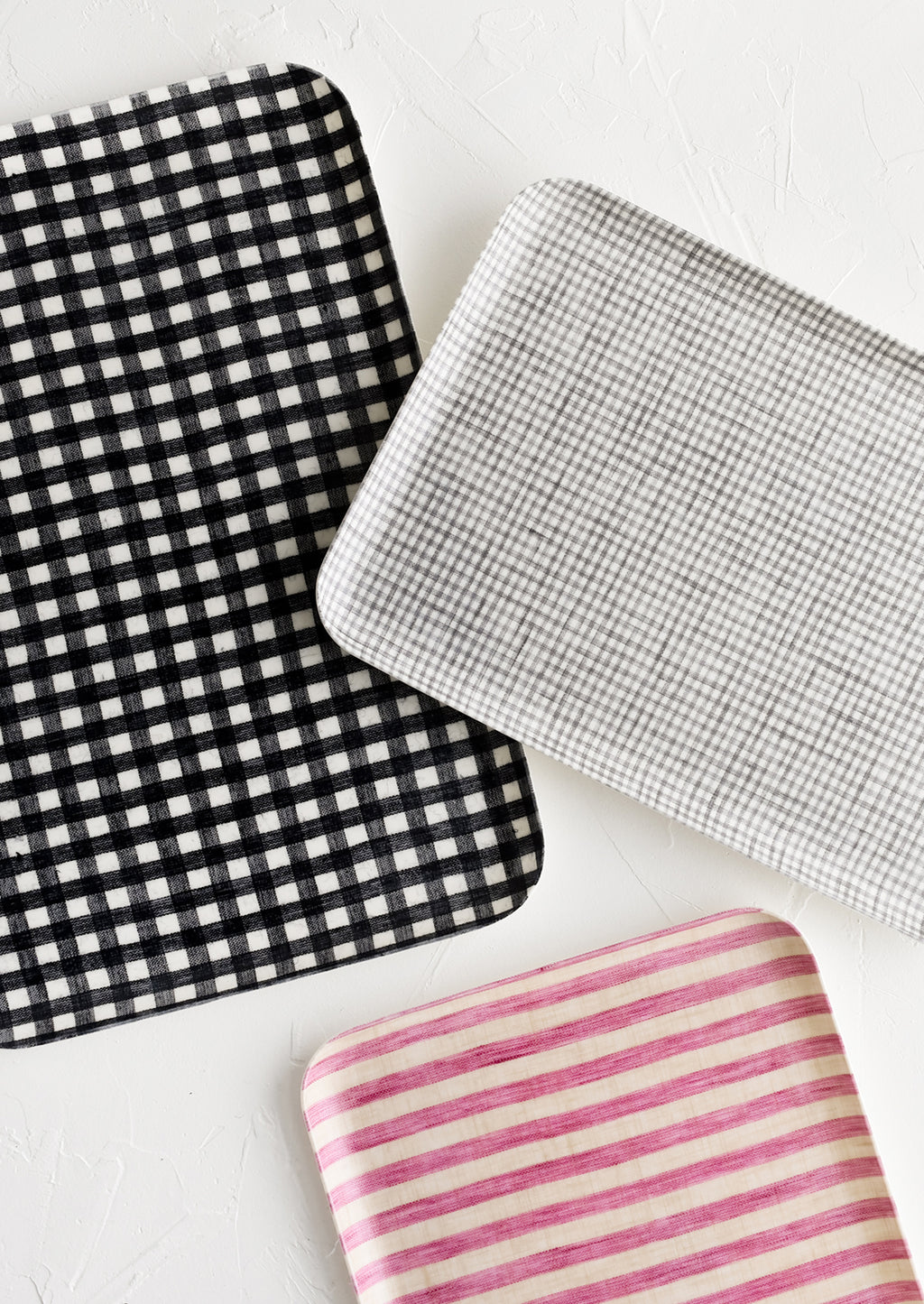 1: Patterned linen trays in assorted sizes and colors.
