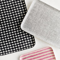 1: Patterned linen trays in assorted sizes and colors.