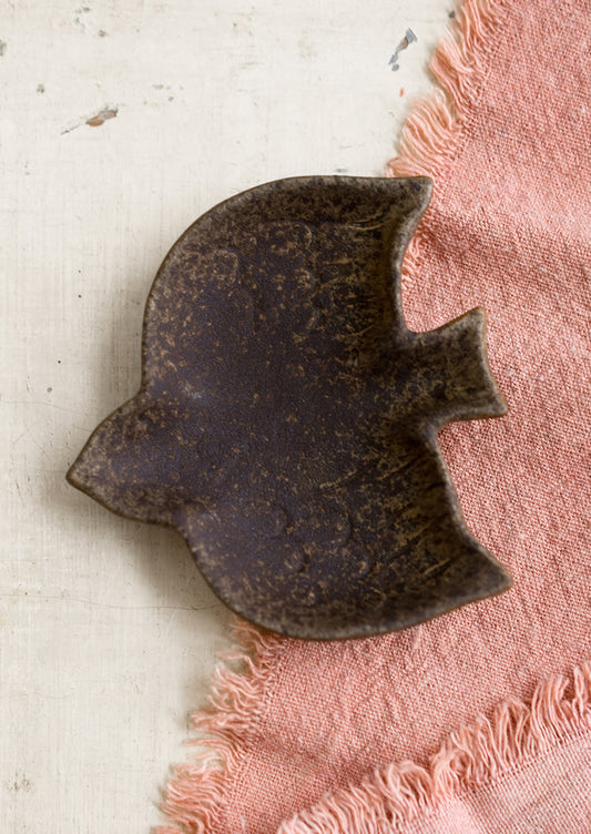 A bird shaped trinket dish in dark brown.