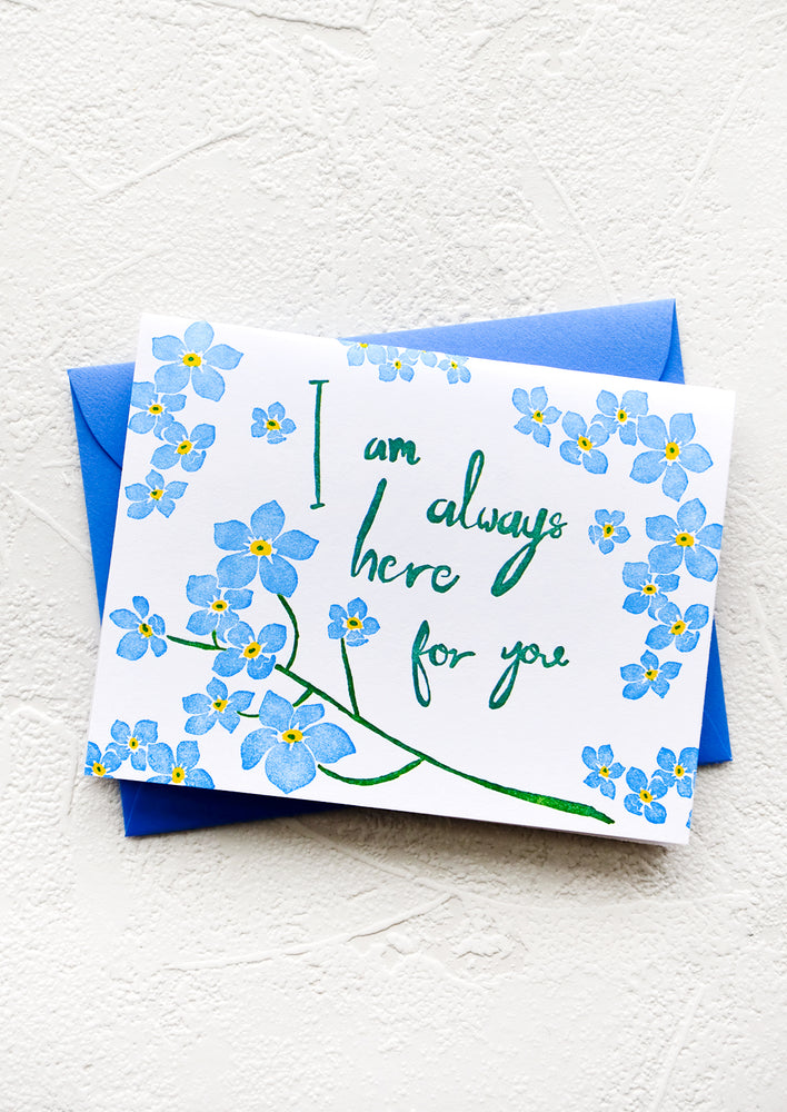1: Greeting card with blue flowers and green cursive text reading "I am always here for you"