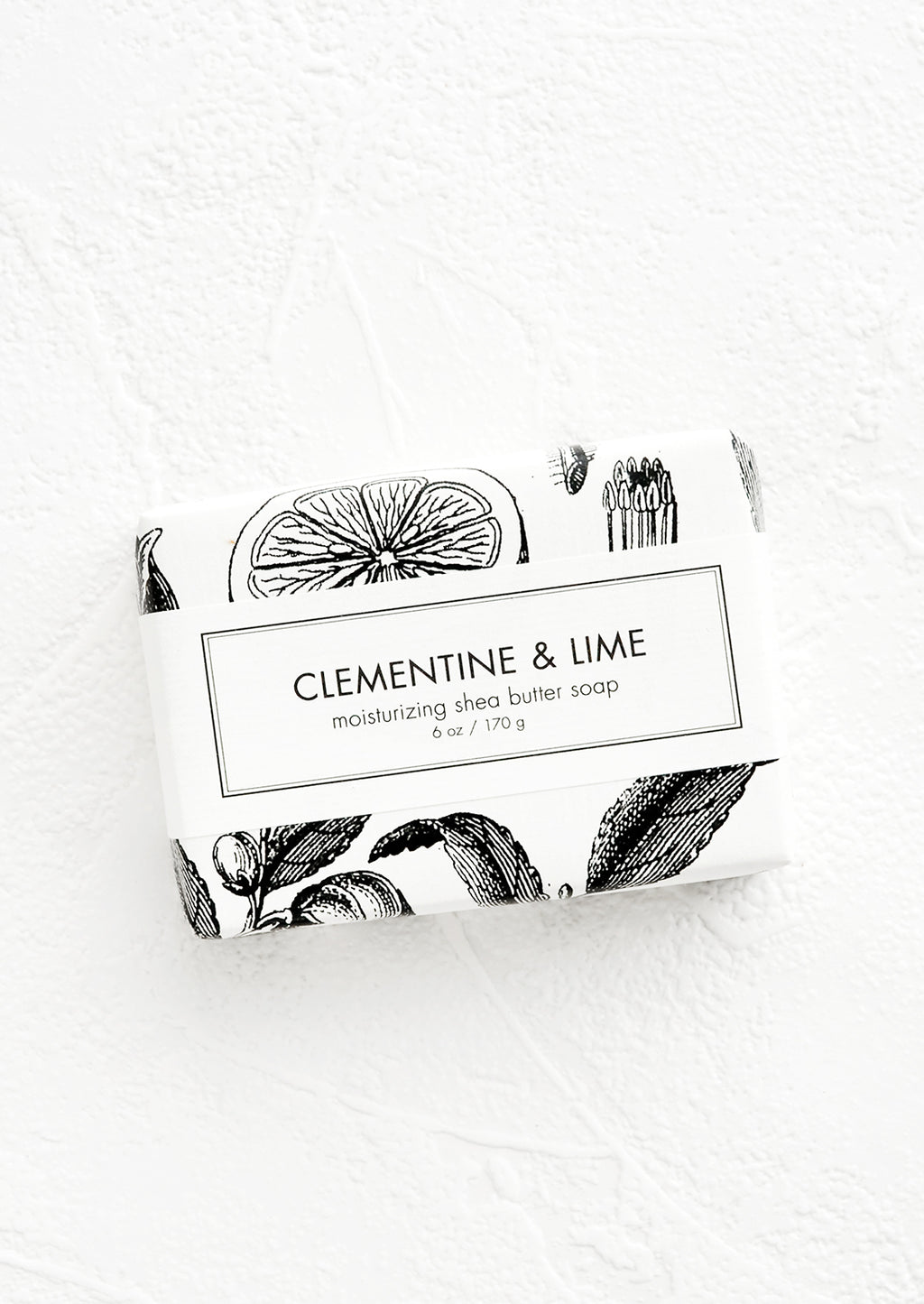 Clementine & Lime: A bar of soap in black & white botanical graphic packaging.