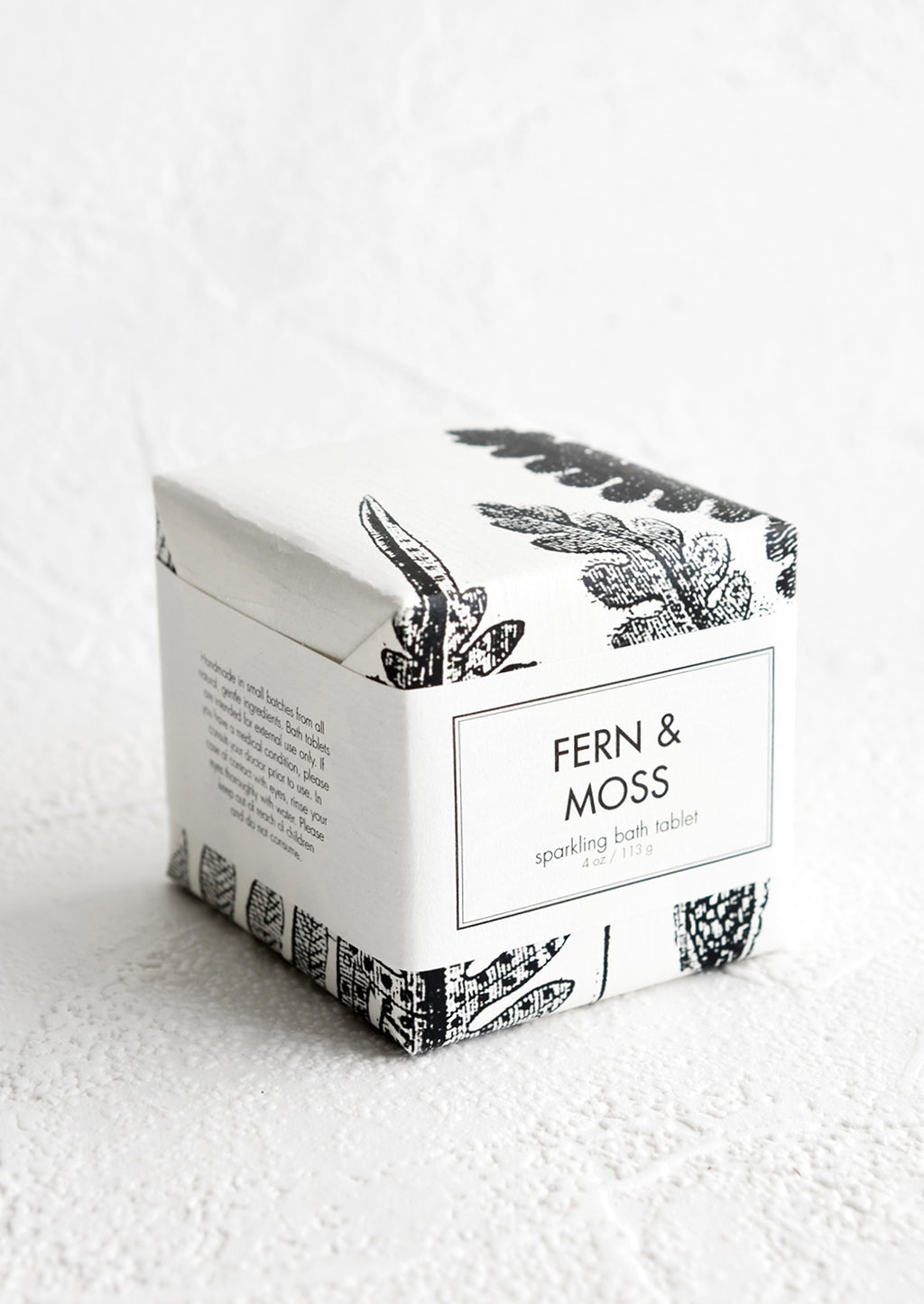 Fern & Moss: A cube-shaped bath fizzy box with black and white botanical graphic packaging.