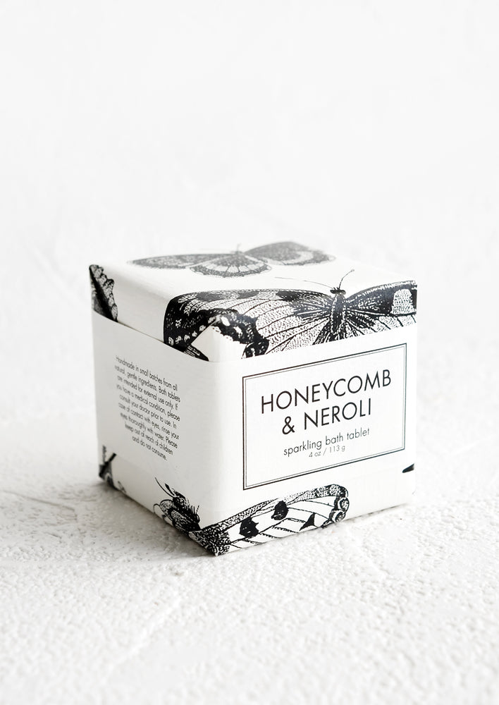 Honeycomb & Neroli: A cube-shaped bath fizzy box with black and white butterfly graphic packaging.