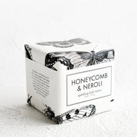 Honeycomb & Neroli: A cube-shaped bath fizzy box with black and white butterfly graphic packaging.