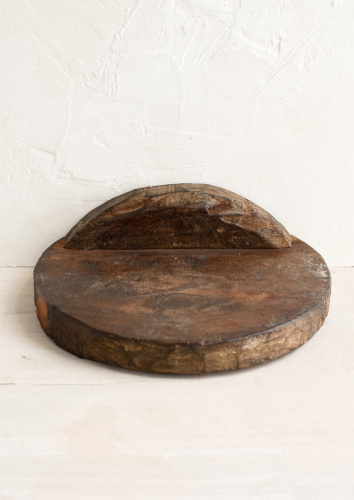 A small wall shelf made from a vintage bread board.
