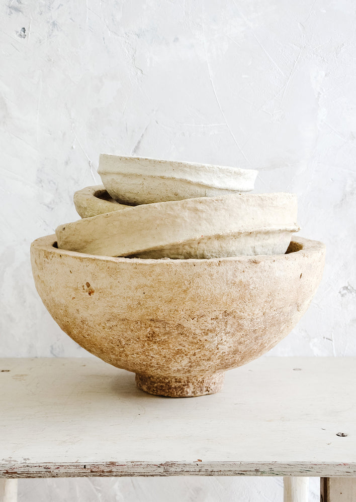 Stack of vintage paper mache bowls in incremental sizes