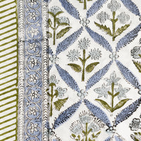 3: A block printed floral tablecloth in blue and green.