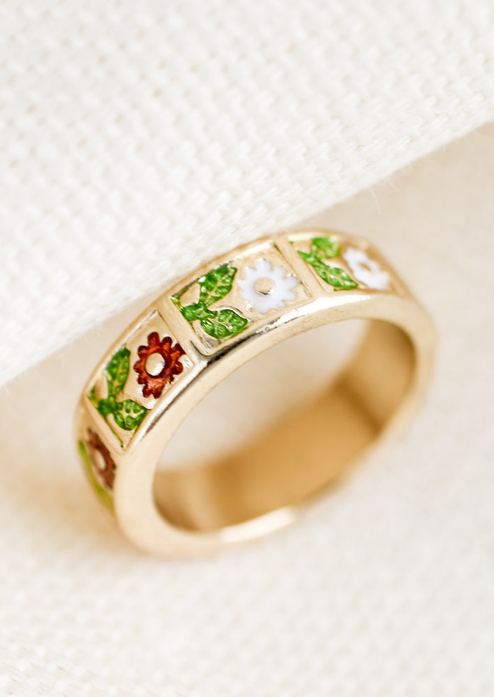 1: A gold ring with enamel floral design.