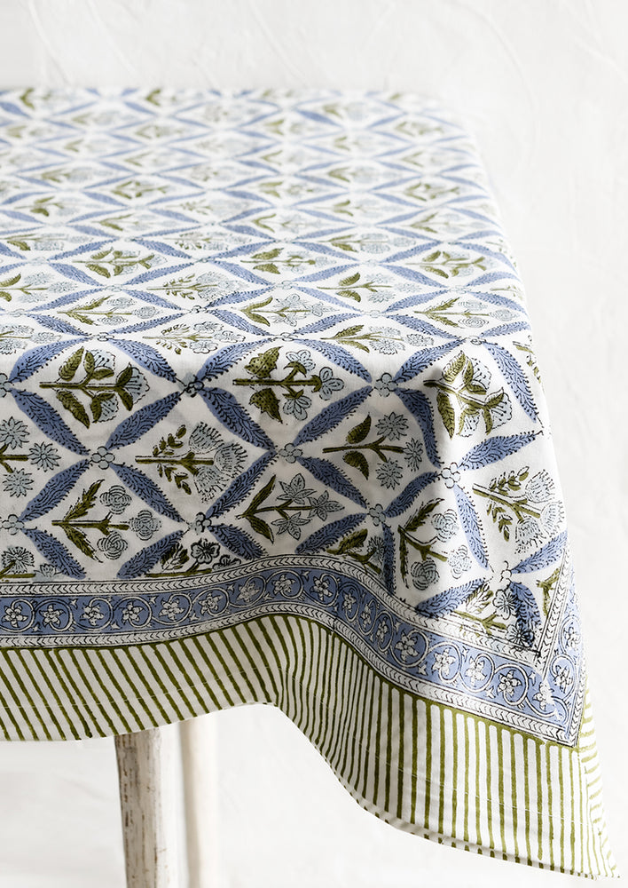 A block printed floral tablecloth in blue and green.