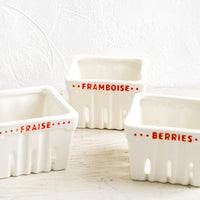 1: Ceramic berry baskets made to look like the disposable variety, but in white ceramic with red letters in French.