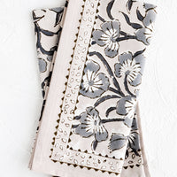 1: A pair of block printed napkins in purple-grey color with bordered floral pattern.