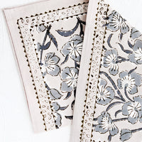 2: A block printed napkin in purple-grey color with bordered floral pattern.