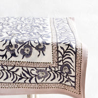 2: Tablecloth featuring bordered floral pattern displayed on a table.