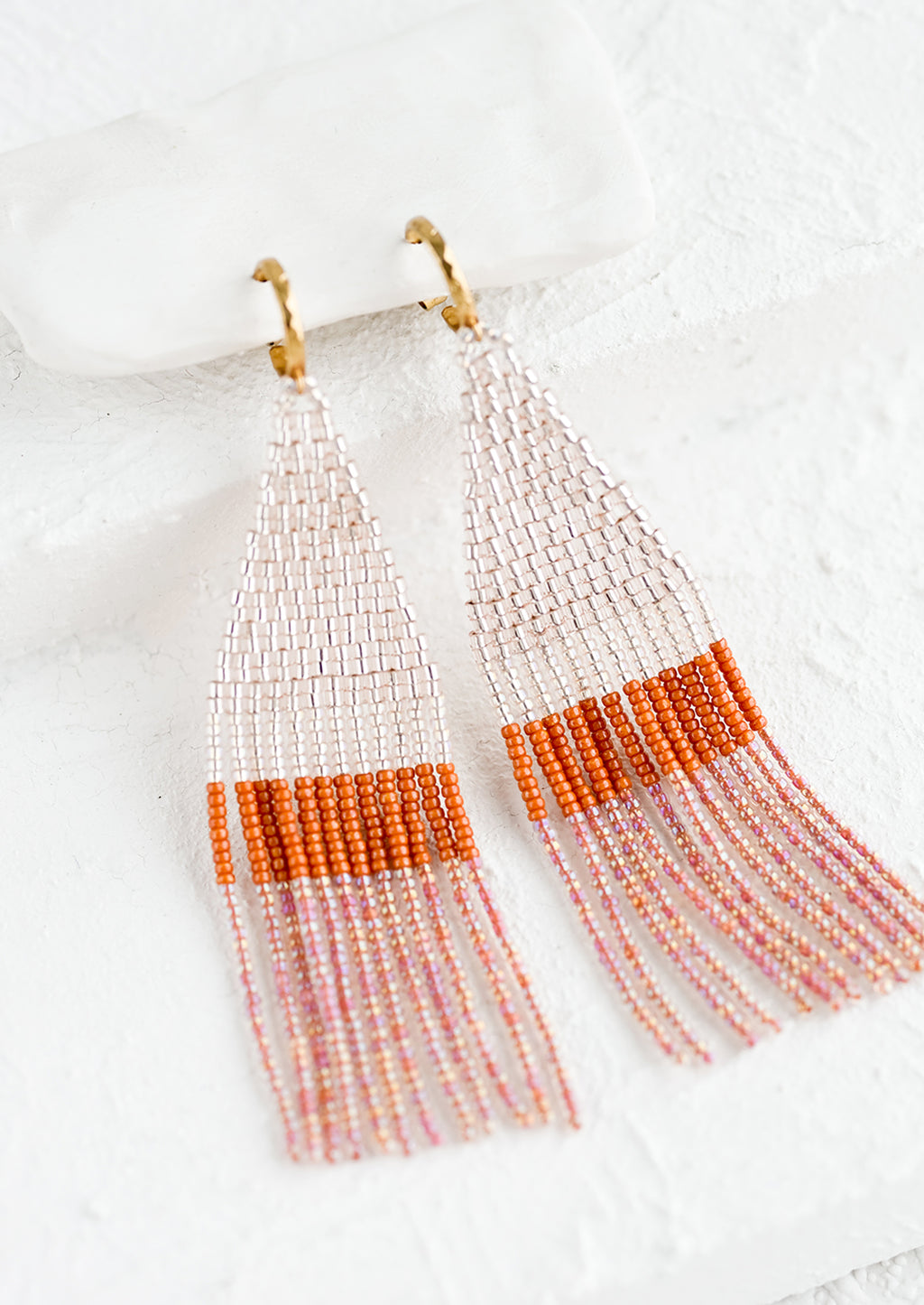 Blush Multi: Beaded earrings featuring pink and rust beads layered into fringe, dangling from a gold hoop.