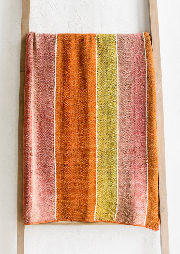 1: A vintage frazada textile in wide stripe pattern in orange, pink and yellow.