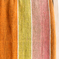 2: A vintage frazada textile in wide stripe pattern in orange, pink and yellow.