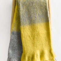 1: A mohair throw in grey and yellow.