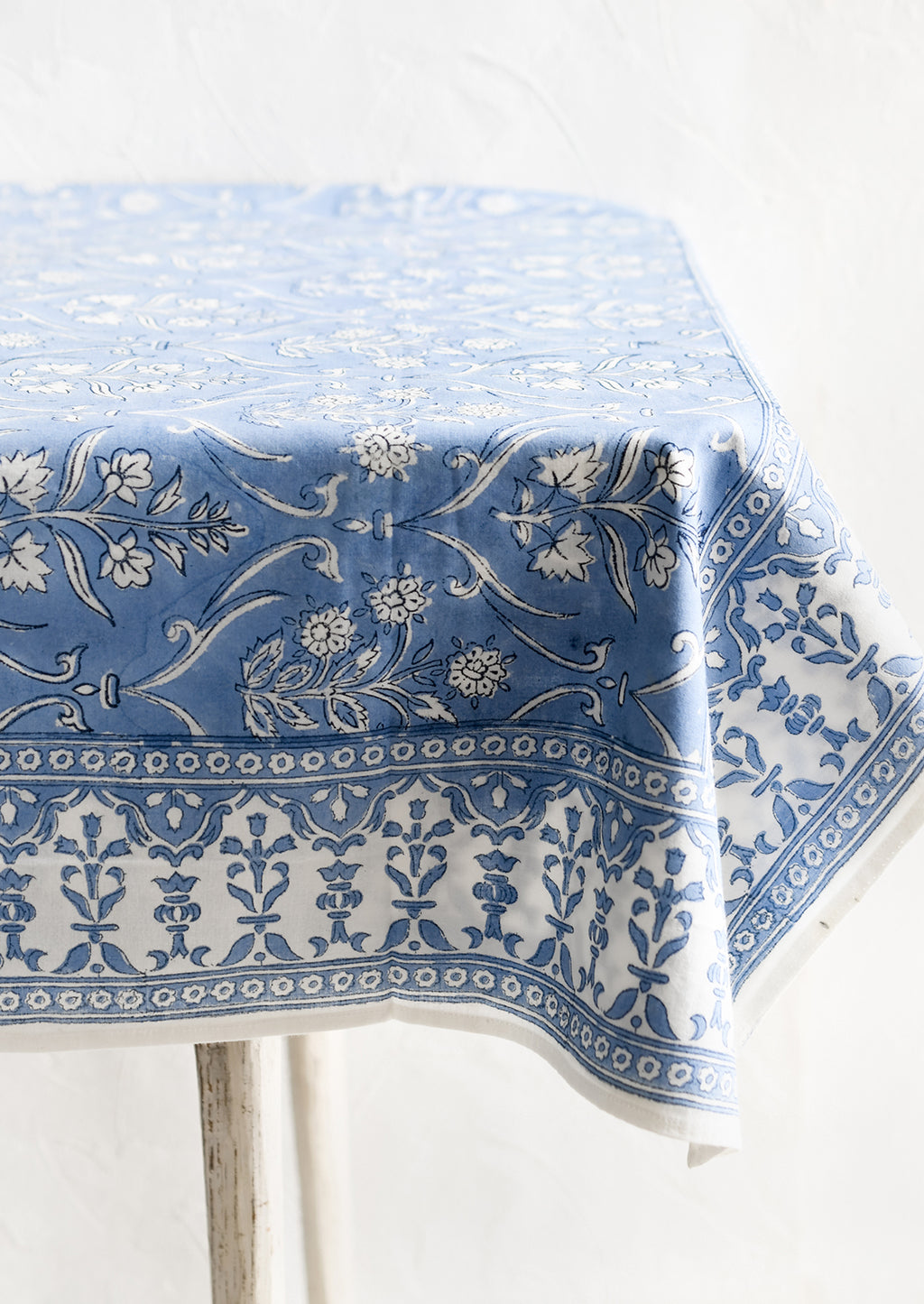 2: A floral print tablecloth in blue and white.