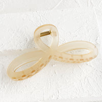Matte Honey: A curvy hair clip with knotted loop design in frosted tan.