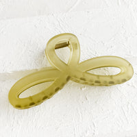 Matte Olive: A curvy hair clip with knotted loop design in frosted olive.