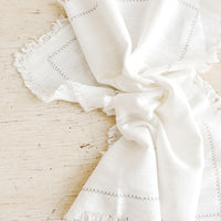 3: White cotton dinner napkin with frayed edges and stitched border detail