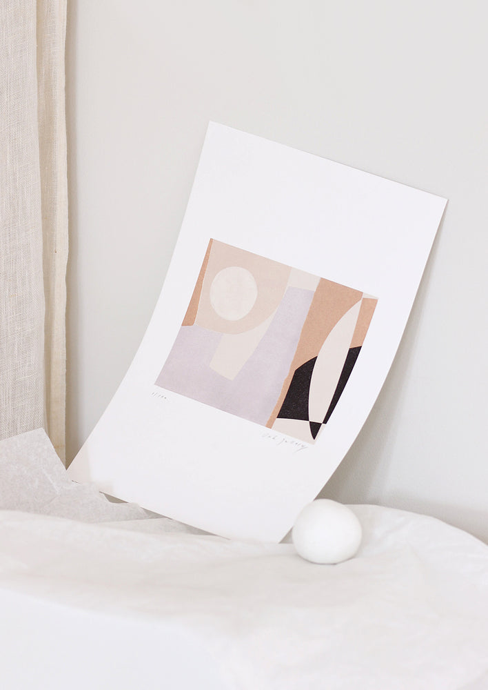 An abstract art print styled in a minimal, decorative setting.